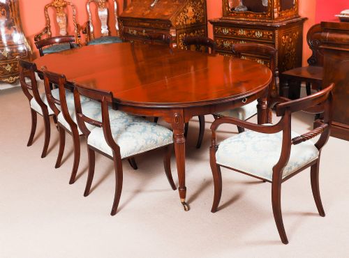 fig 2. An antique Victorian flame mahogany extending dining table with fluted tapering legs set on brass castors.