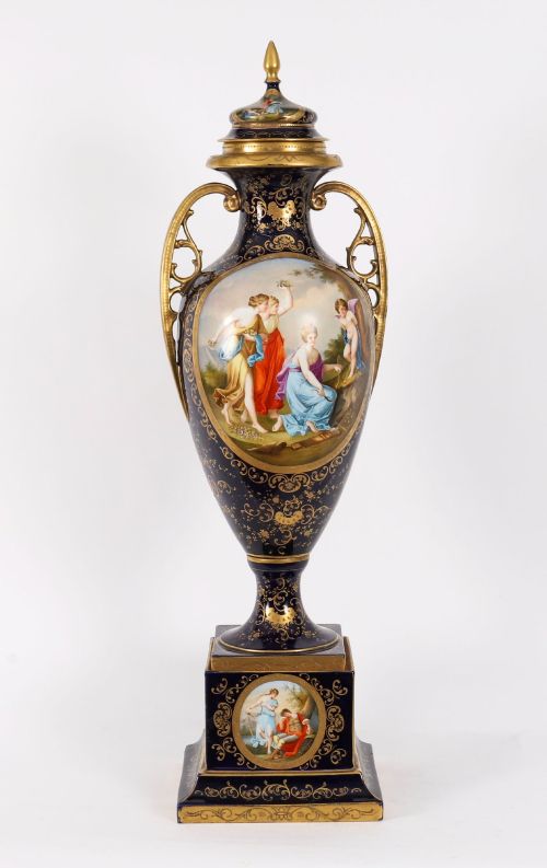 fig 1. A pair of large 19th-century cobalt blue porcelain vases on matching square pedestals, featuring gilt scrollwork and hand-painted classical mythological scenes.