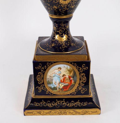 fig 3. A pair of large 19th-century cobalt blue porcelain vases on matching square pedestals, featuring gilt scrollwork and hand-painted classical mythological scenes.