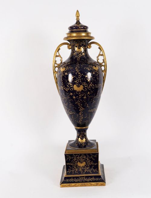 fig 5. A pair of large 19th-century cobalt blue porcelain vases on matching square pedestals, featuring gilt scrollwork and hand-painted classical mythological scenes.