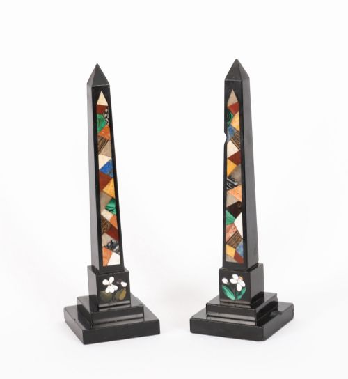 fig 1. A pair of antique black marble obelisks featuring colourful geometric stone inlays along the shaft and floral inlaid detail on stepped square bases.