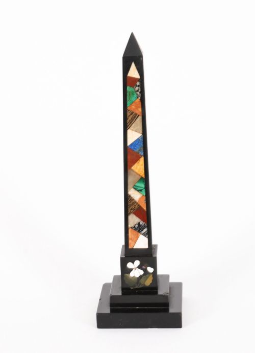 fig 2. A pair of antique black marble obelisks featuring colourful geometric stone inlays along the shaft and floral inlaid detail on stepped square bases.