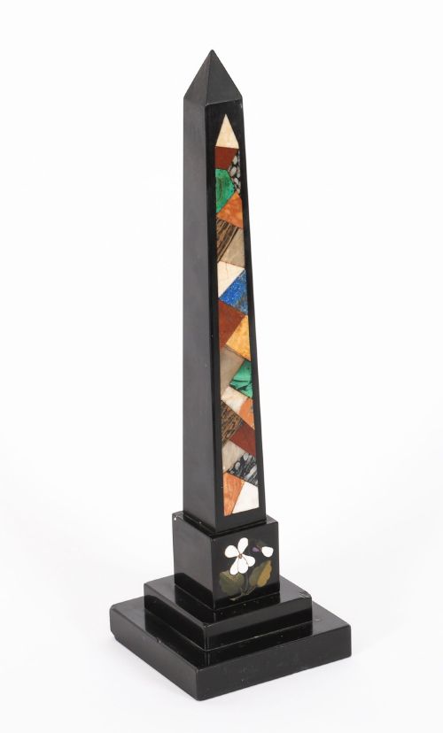 fig 3. A pair of antique black marble obelisks featuring colourful geometric stone inlays along the shaft and floral inlaid detail on stepped square bases.