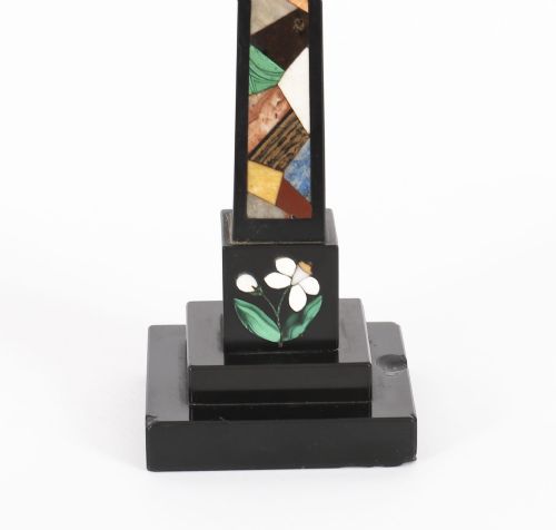 fig 5. A pair of antique black marble obelisks featuring colourful geometric stone inlays along the shaft and floral inlaid detail on stepped square bases.