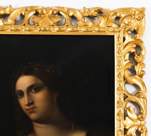 fig 5. An early 19th-century portrait oil painting of a woman in classical attire set within a heavily carved gold giltwood frame.