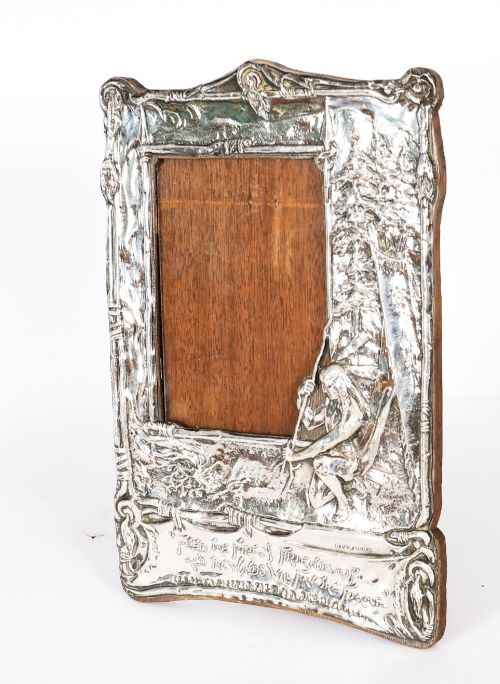 fig 1. An Edwardian sterling silver picture frame featuring an embossed relief scene of Hiawatha with a wooden backing.