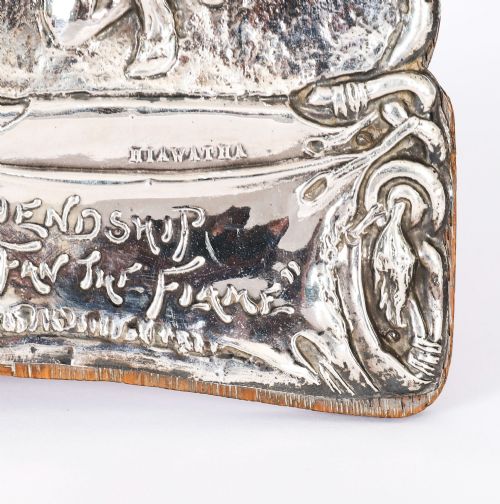 fig 3. An Edwardian sterling silver picture frame featuring an embossed relief scene of Hiawatha with a wooden backing.
