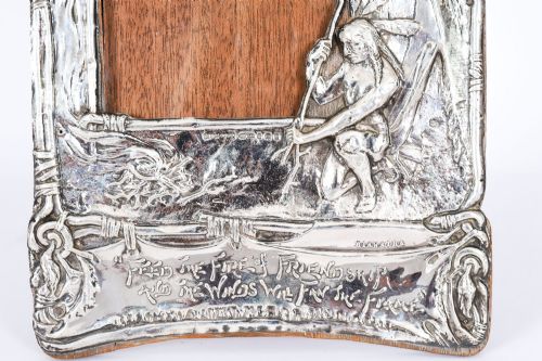 fig 4. An Edwardian sterling silver picture frame featuring an embossed relief scene of Hiawatha with a wooden backing.