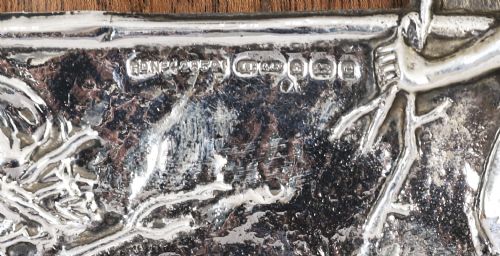 fig 5. An Edwardian sterling silver picture frame featuring an embossed relief scene of Hiawatha with a wooden backing.