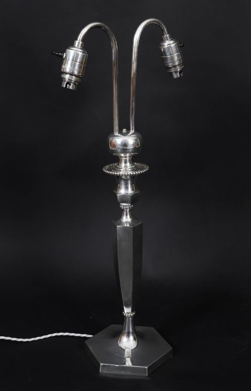 fig 1. An Art Deco silver-plated twin-arm table lamp with a faceted stem and hexagonal base.