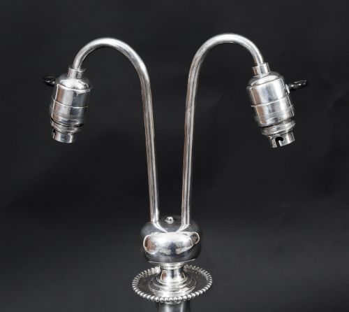 fig 2. An Art Deco silver-plated twin-arm table lamp with a faceted stem and hexagonal base.