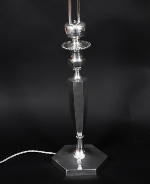fig 4. An Art Deco silver-plated twin-arm table lamp with a faceted stem and hexagonal base.