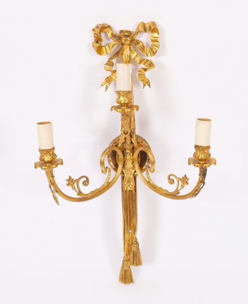 fig 1. A pair of 19th-century French gilt bronze three-branch wall sconces styled with ribbon bow tops and tassel finials.