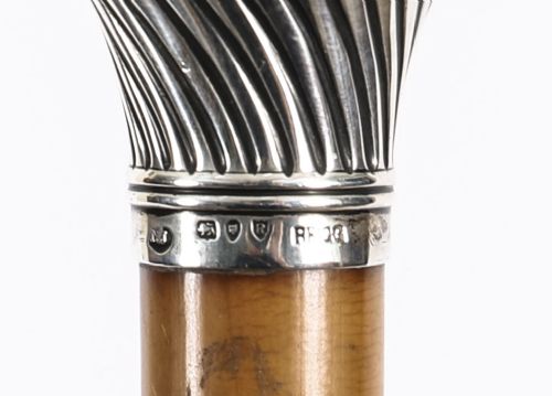 Victorian walking cane featuring an engraved sterling silver pommel with spiralled fluting mounted on a light wood shaft. View IX