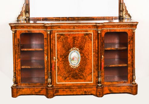 fig 1. A nineteenth-century Victorian burr walnut credenza featuring an arched mirror back, glazed side doors, and a central cupboard inlaid with a porcelain plaque.