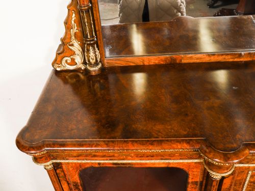 fig 4. A nineteenth-century Victorian burr walnut credenza featuring an arched mirror back, glazed side doors, and a central cupboard inlaid with a porcelain plaque.