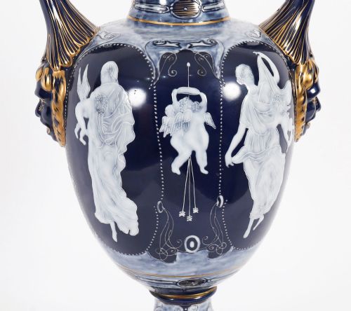 fig 8. A pair of cobalt blue and white porcelain lidded vases featuring classical figures, scrolling handles, and gilded finials.