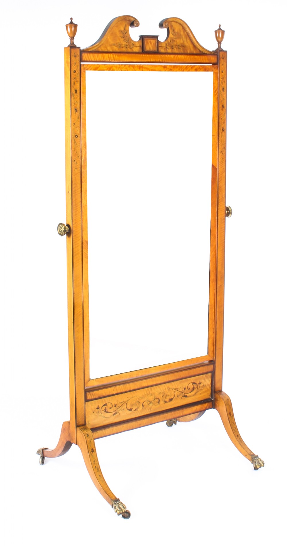 An Edwardian satinwood cheval mirror featuring intricate marquetry inlay, an arched pediment with finials, side adjusters, and splayed legs with brass castors.