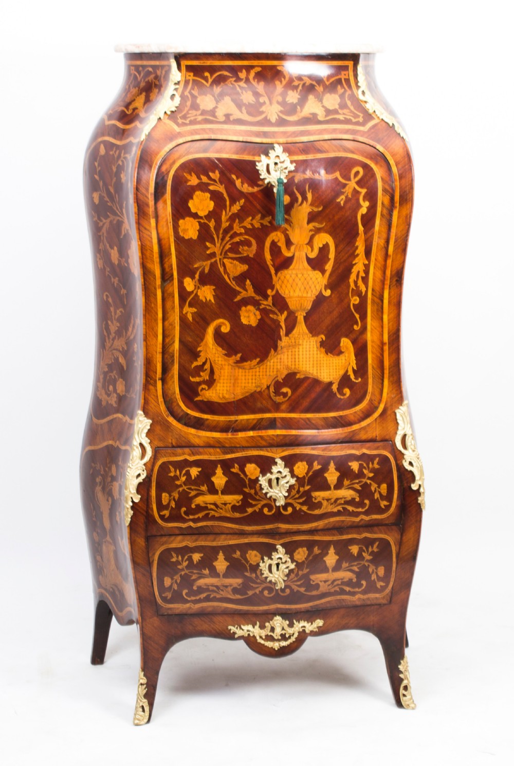 A 19th-century French Rococo Revival secretaire a abattant crafted with floral marquetry, gilt bronze mounts, a contoured silhouette, and a marble top.