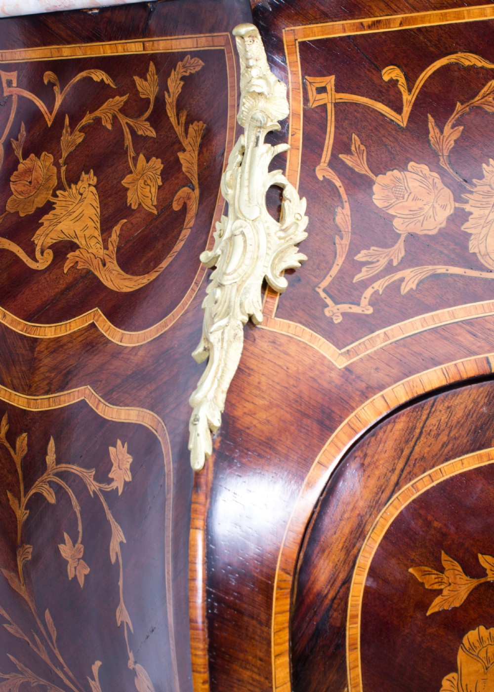 A 19th-century French Rococo Revival secretaire a abattant crafted with floral marquetry, gilt bronze mounts, a contoured silhouette, and a marble top. View V