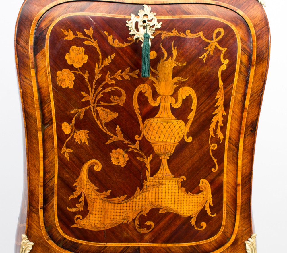 A 19th-century French Rococo Revival secretaire a abattant crafted with floral marquetry, gilt bronze mounts, a contoured silhouette, and a marble top. View VII