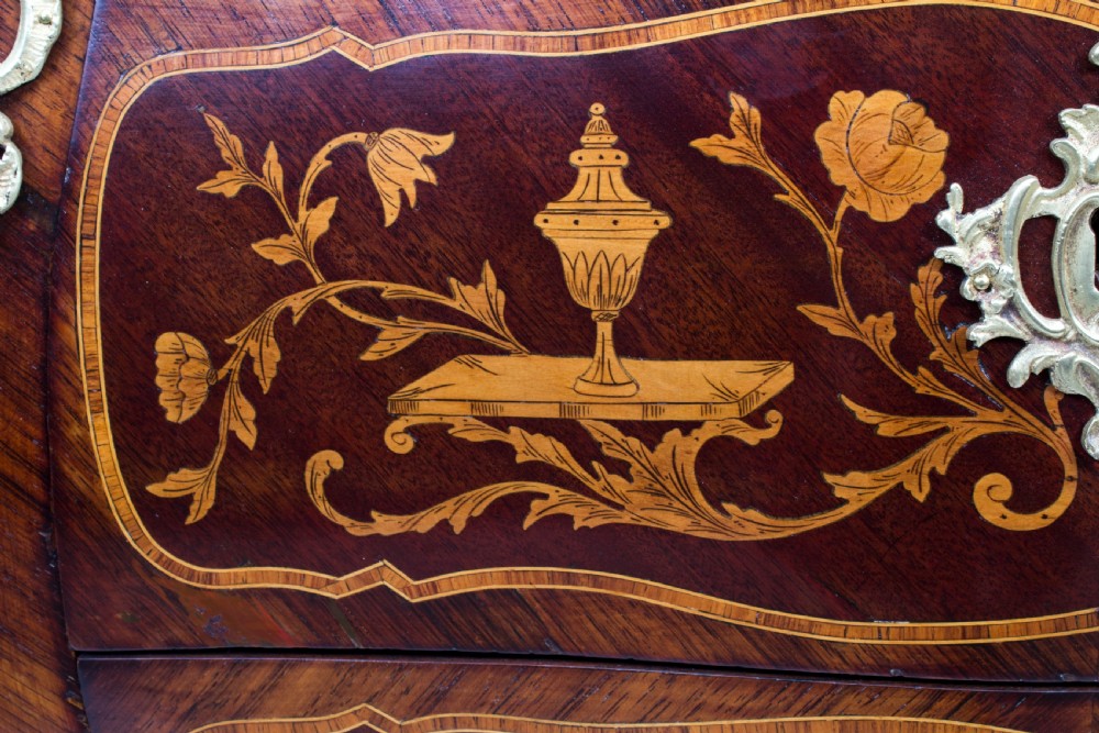 A 19th-century French Rococo Revival secretaire a abattant crafted with floral marquetry, gilt bronze mounts, a contoured silhouette, and a marble top. View X