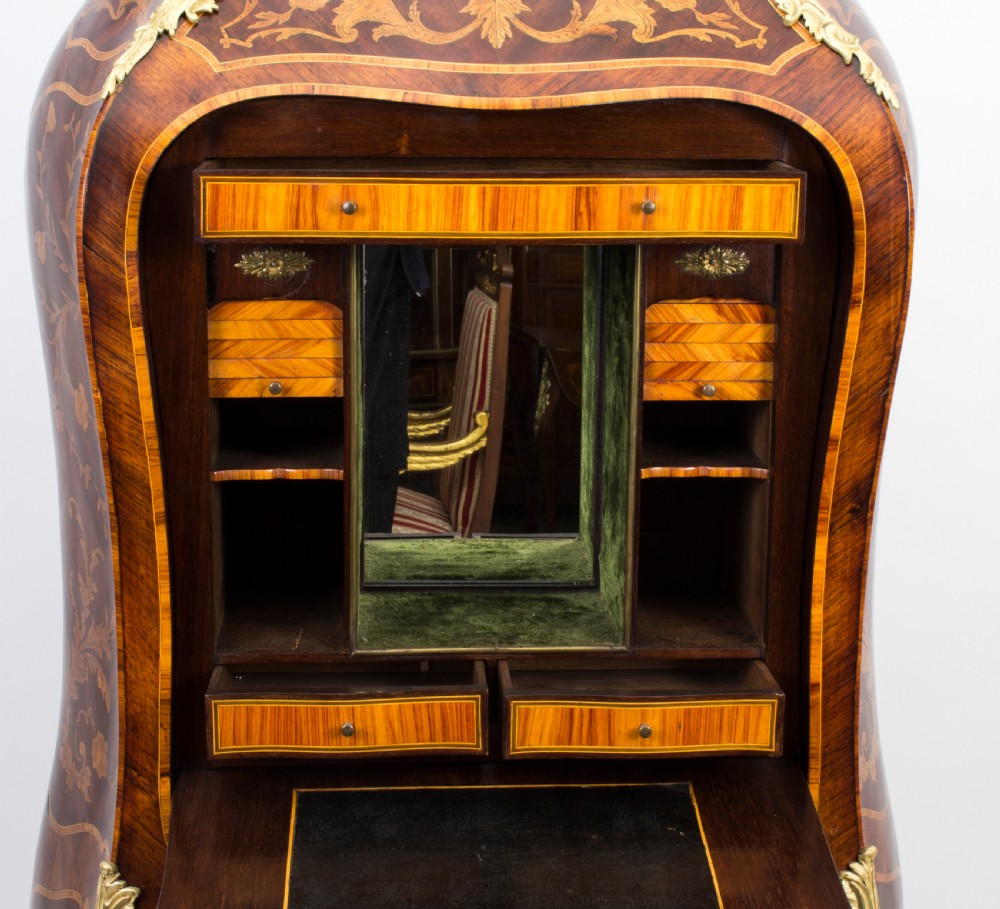 A 19th-century French Rococo Revival secretaire a abattant crafted with floral marquetry, gilt bronze mounts, a contoured silhouette, and a marble top. View XIV
