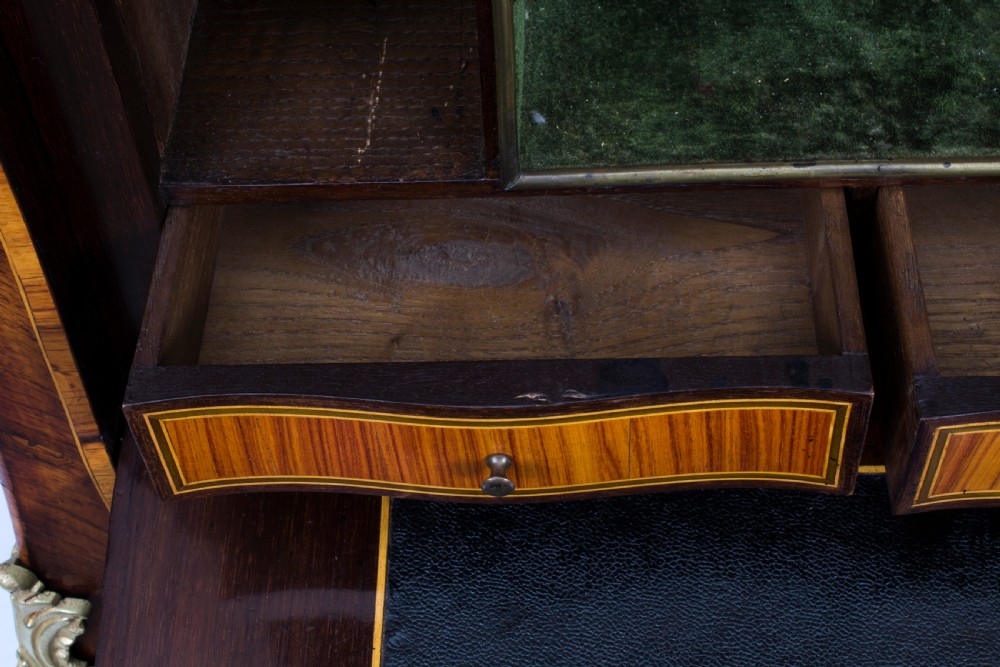 A 19th-century French Rococo Revival secretaire a abattant crafted with floral marquetry, gilt bronze mounts, a contoured silhouette, and a marble top. View XVIII