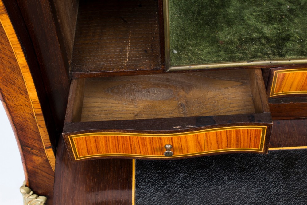 A 19th-century French Rococo Revival secretaire a abattant crafted with floral marquetry, gilt bronze mounts, a contoured silhouette, and a marble top. View XIX