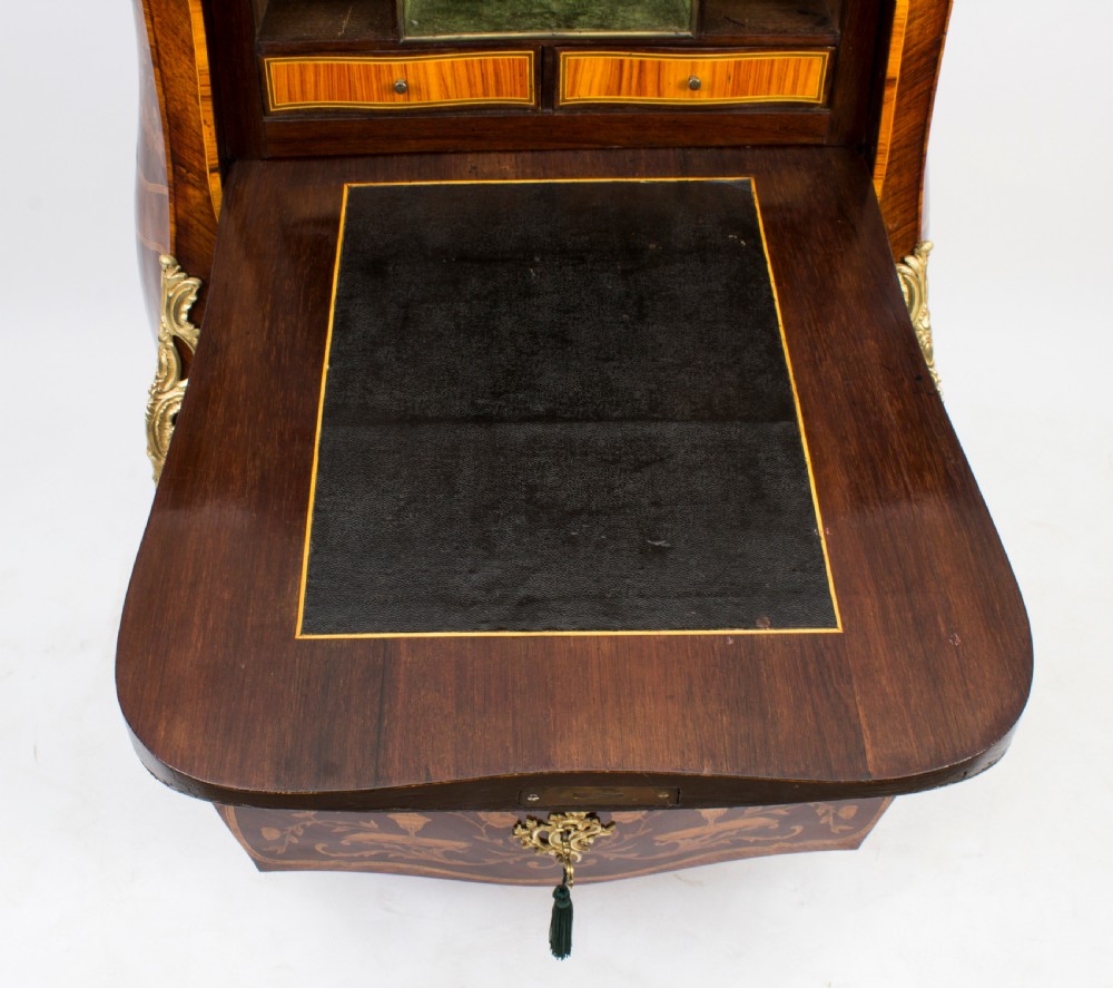 A 19th-century French Rococo Revival secretaire a abattant crafted with floral marquetry, gilt bronze mounts, a contoured silhouette, and a marble top. View XX
