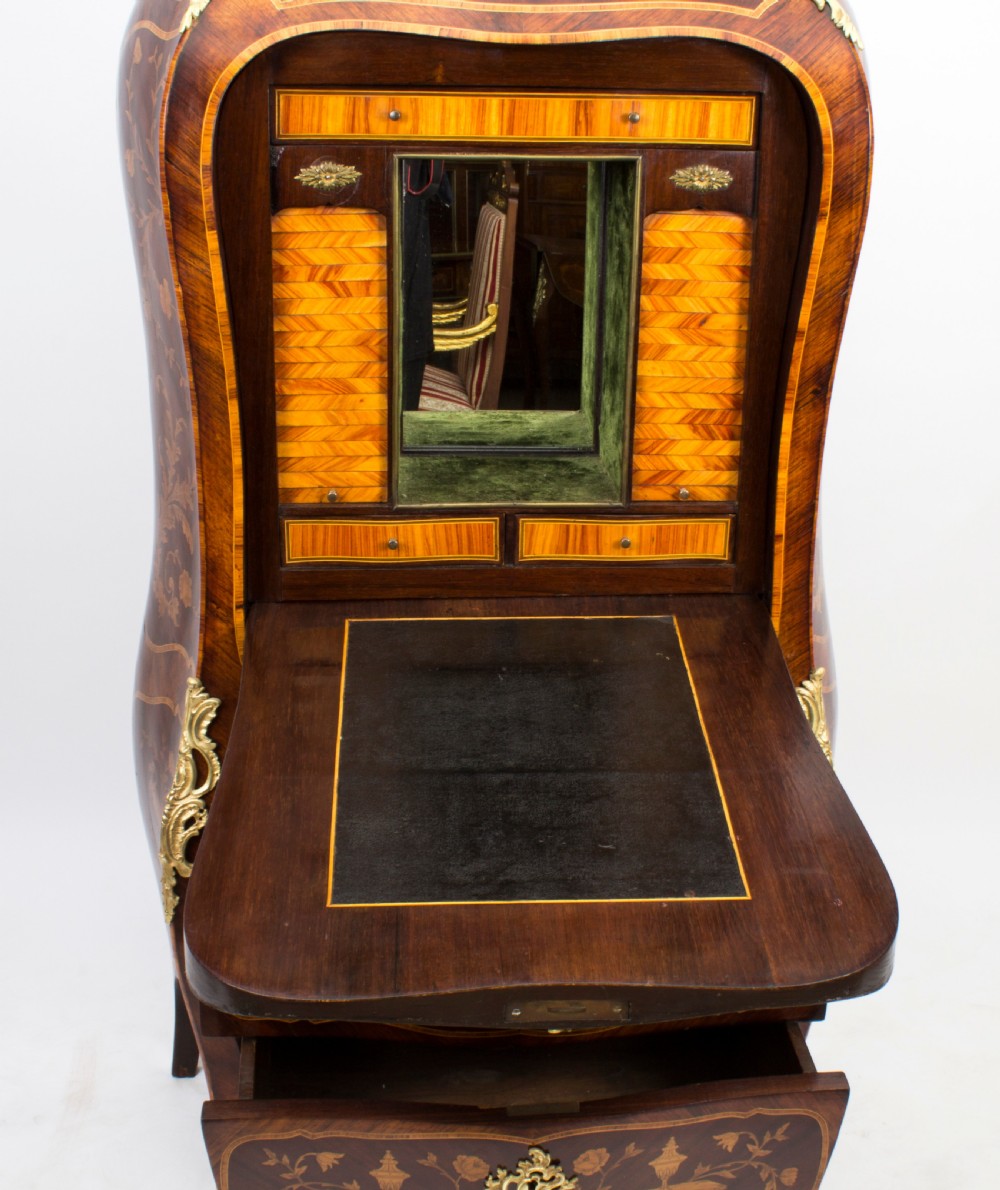 A 19th-century French Rococo Revival secretaire a abattant crafted with floral marquetry, gilt bronze mounts, a contoured silhouette, and a marble top. View XXI