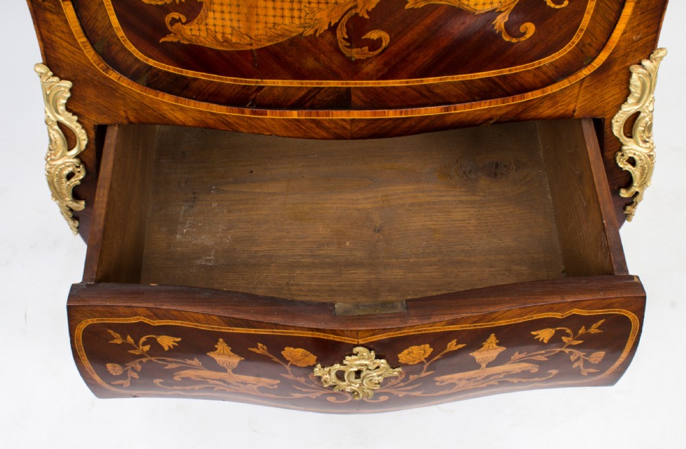 A 19th-century French Rococo Revival secretaire a abattant crafted with floral marquetry, gilt bronze mounts, a contoured silhouette, and a marble top. View XXII
