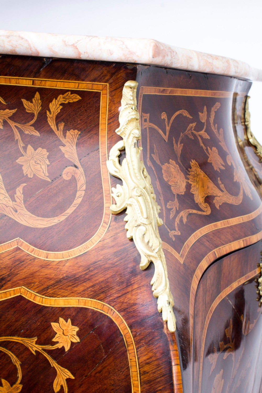 A 19th-century French Rococo Revival secretaire a abattant crafted with floral marquetry, gilt bronze mounts, a contoured silhouette, and a marble top. View XXVI