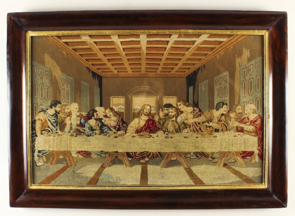 A nineteenth-century framed textile depicting Leonardo da Vincis Last Supper, set within a dark polished wooden frame with a thin gilt inner margin.