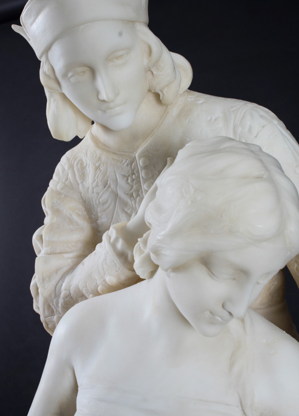 A 19th-century white carved alabaster sculpture depicting a seated female figure in drapery with a male figure standing behind her. View V