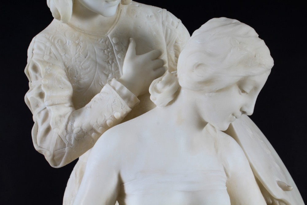 A 19th-century white carved alabaster sculpture depicting a seated female figure in drapery with a male figure standing behind her. View IX