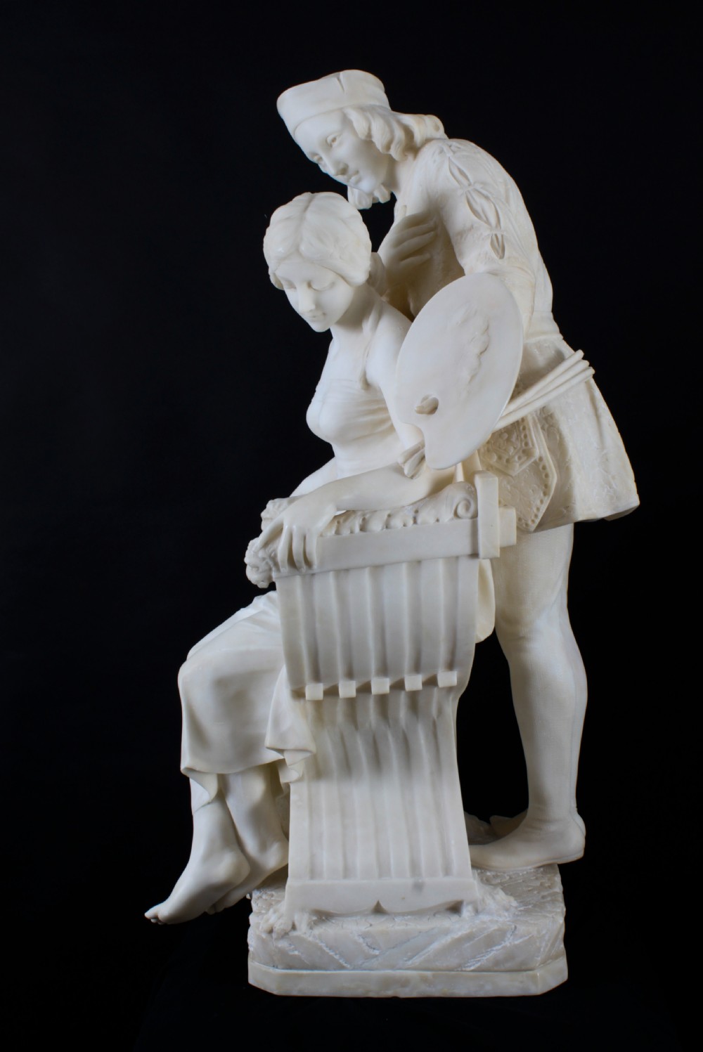 A 19th-century white carved alabaster sculpture depicting a seated female figure in drapery with a male figure standing behind her. View X