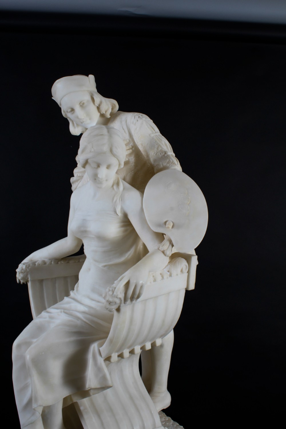 A 19th-century white carved alabaster sculpture depicting a seated female figure in drapery with a male figure standing behind her. View XII