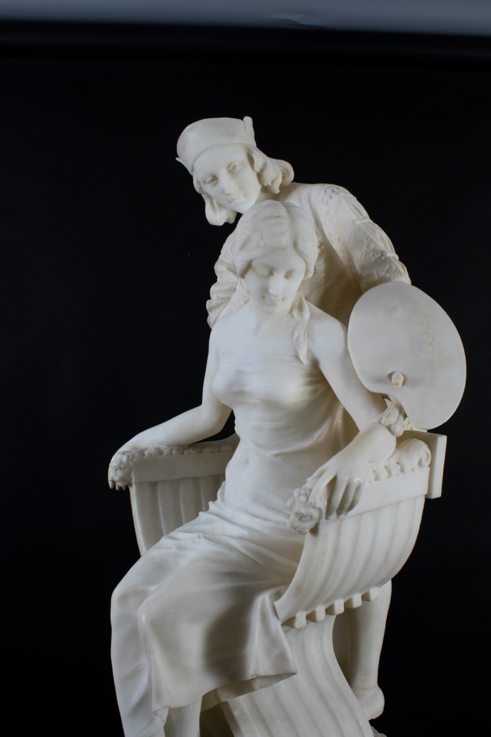 A 19th-century white carved alabaster sculpture depicting a seated female figure in drapery with a male figure standing behind her. View XIV