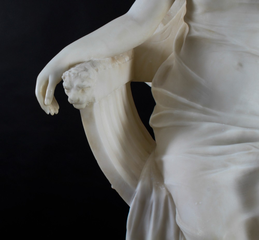 A 19th-century white carved alabaster sculpture depicting a seated female figure in drapery with a male figure standing behind her. View XX