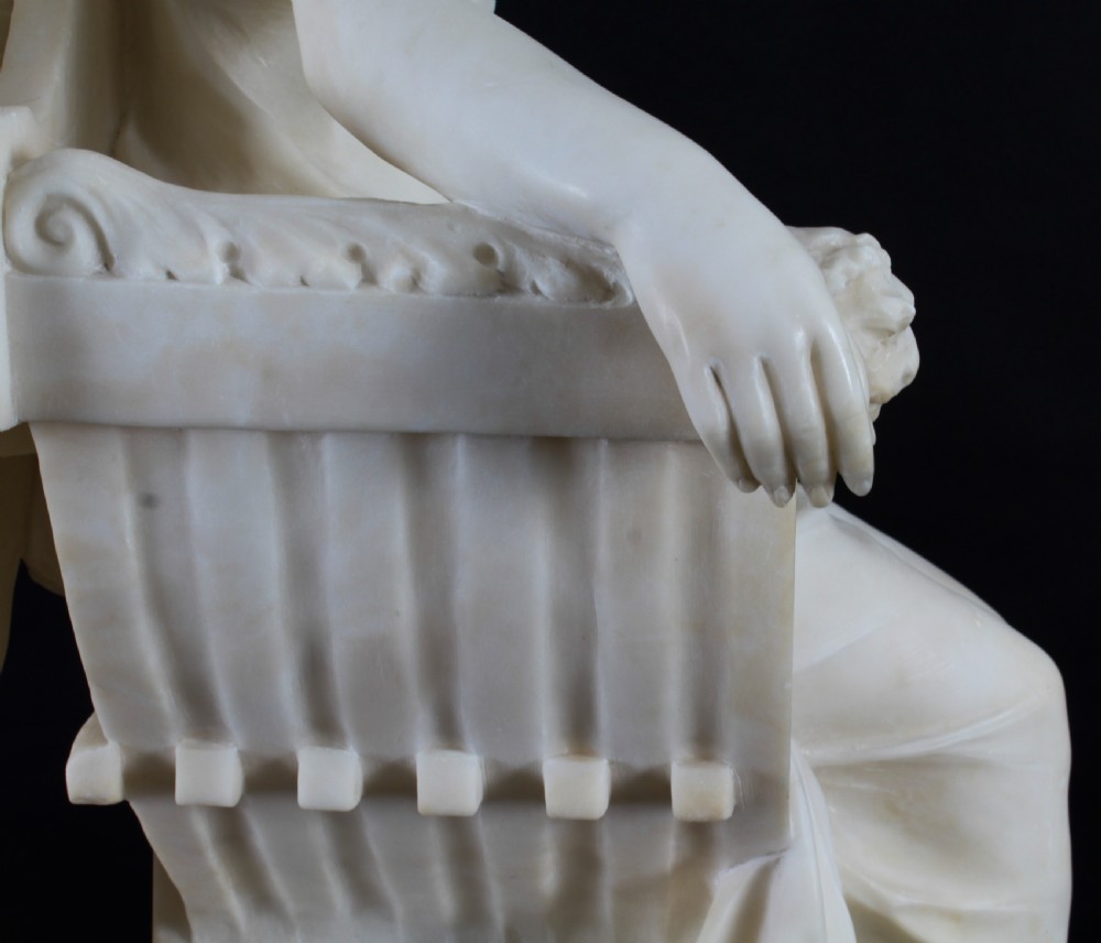 A 19th-century white carved alabaster sculpture depicting a seated female figure in drapery with a male figure standing behind her. View XXV