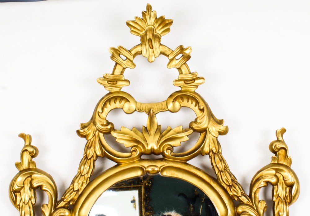 A matching pair of 19th-century Florentine Rococo carved giltwood wall mirror frames featuring intricate acanthus leaf cresting and scrollwork. View VIII