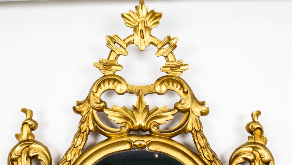 A matching pair of 19th-century Florentine Rococo carved giltwood wall mirror frames featuring intricate acanthus leaf cresting and scrollwork. View IX