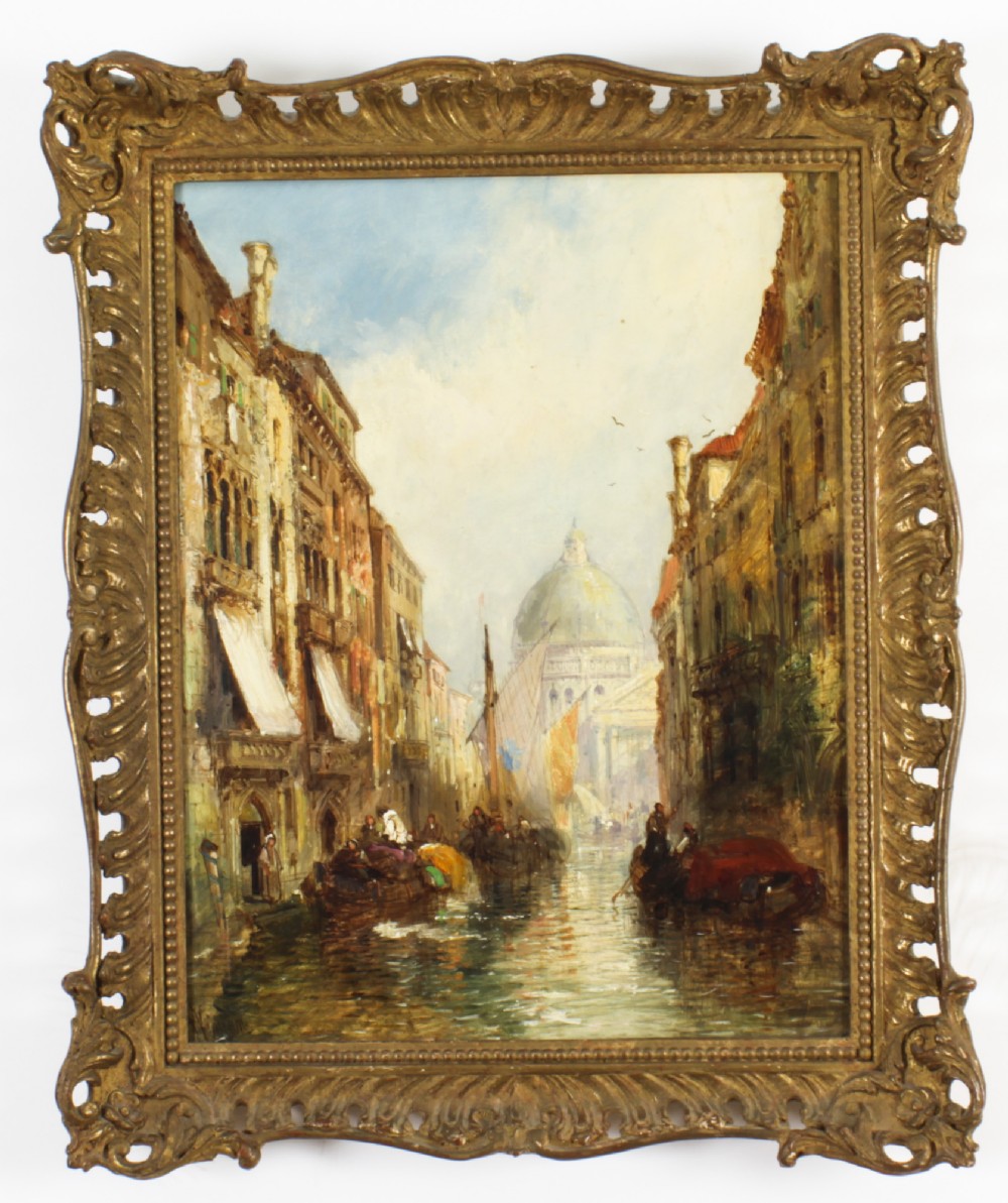 A 19th-century oil painting depicting a Venetian canal with boats leading towards a domed church, housed in an ornate carved giltwood frame.