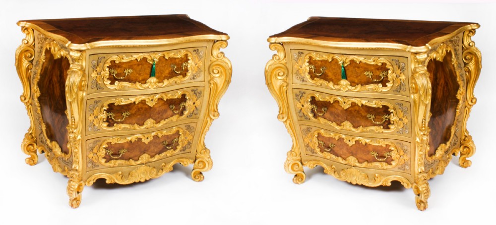 A pair of 19th-century Venetian Rococo commodes featuring burr walnut drawer fronts framed by heavily carved giltwood scrollwork and cabriole legs.