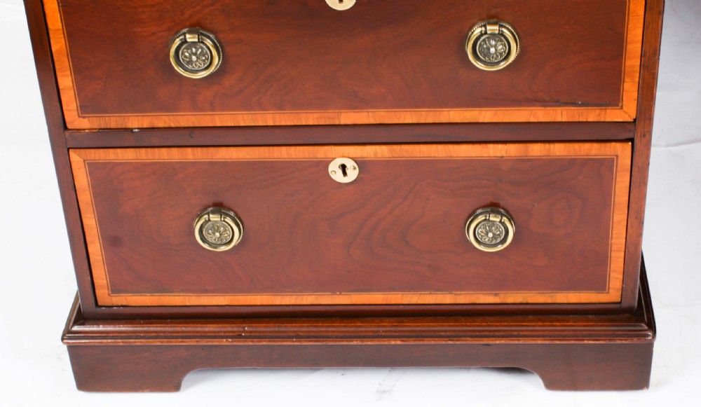 A Victorian flame mahogany partners pedestal desk featuring a green leather inset top and crossbanded drawer fronts with brass ring handles. View XIII