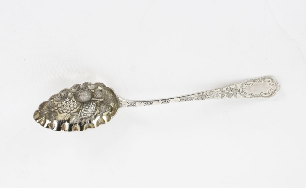 An open wooden case lined with deep purple velvet containing a silver-plated fruit serving set with embossed spoons and nutcrackers. View VIII