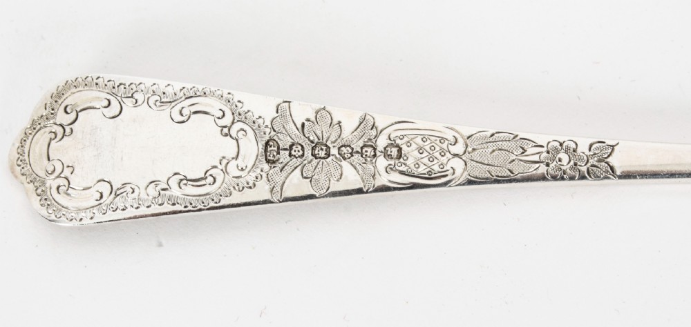 An open wooden case lined with deep purple velvet containing a silver-plated fruit serving set with embossed spoons and nutcrackers. View XIII