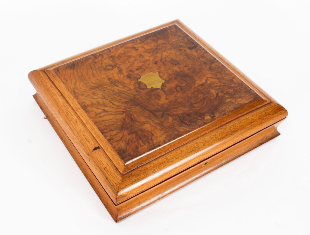 An open wooden case lined with deep purple velvet containing a silver-plated fruit serving set with embossed spoons and nutcrackers. View XXIX