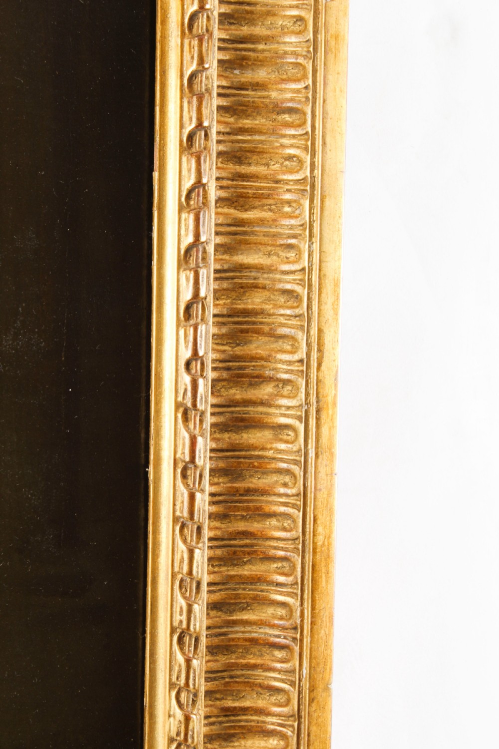 An oil painting depicting a seated young woman wearing a head turban and holding an illuminated scroll, encased in a fluted gold gilded frame. View XIII